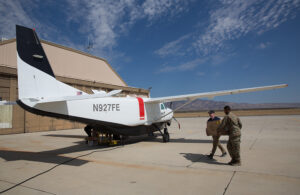 A U.S. Air Force Air Craft being loaded by two people.