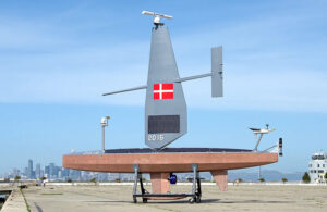 The Saildrone Voyager USV with a Denmark flag on it.
